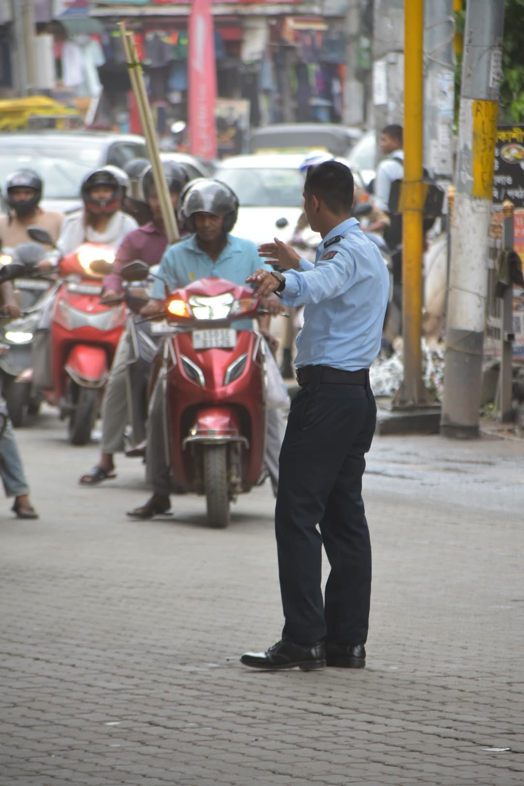 A traffic Police official holding Guwahati traffic at bay.